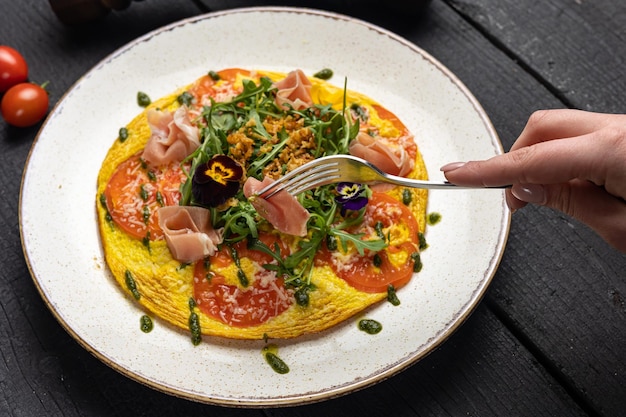 A plate of omelette on a wooden table