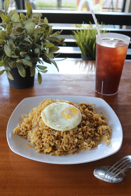 A plate of paella with an egg on top