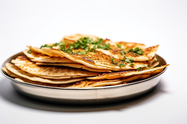 A plate of pancakes with a green garnish on top.