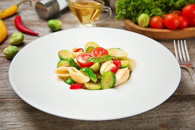 Plate of pasta with Brussels sprouts on table