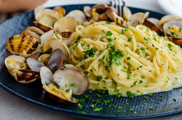 A plate of Pasta with clams and sauce or spaghetti alle vongole