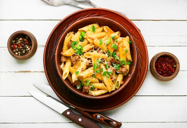 Plate of pasta with fried minced meat.Macaroni with forcemeat.