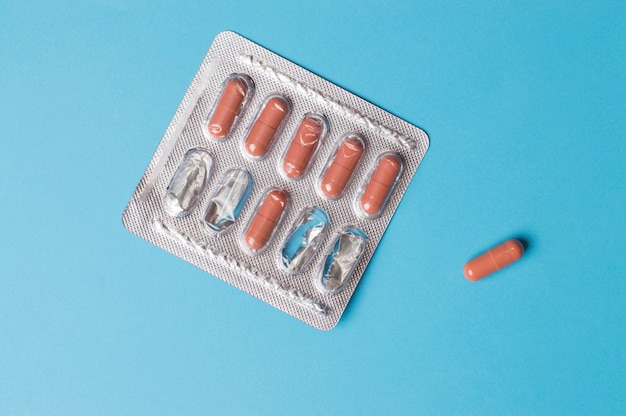 Plate of pills on a blue background