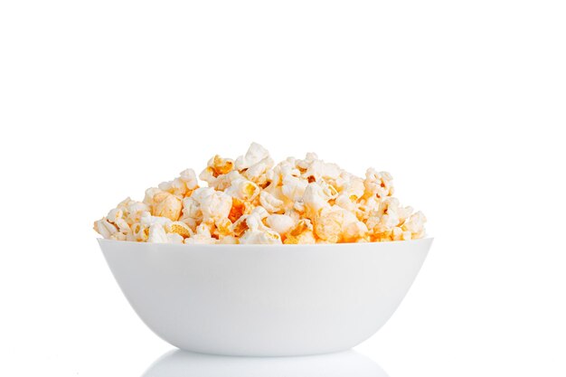 A plate of popcorn macro on a white background