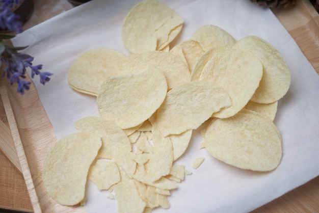 A plate of potato chips with a knife on it