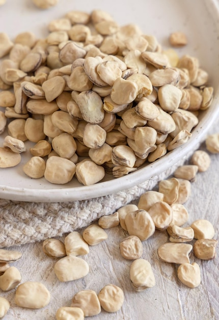 Plate of raw dry Grass pea close up on wooden table Legumes known in Italy as Cicerchia