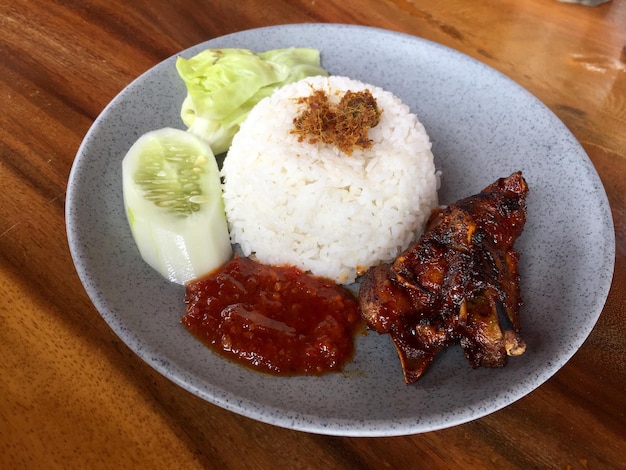 a plate of rice with sweet roasted duck