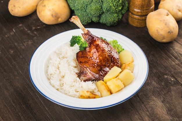 A plate of roast duck leg rice