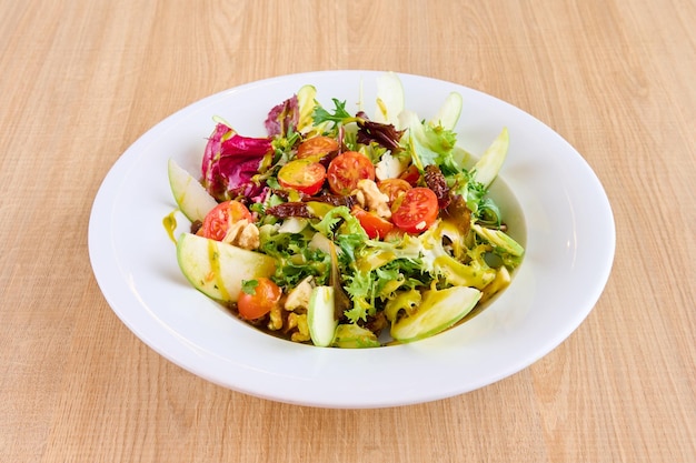 Plate of salad with apple