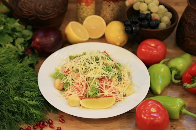 A plate of salad with lemons and a lemon on the side.