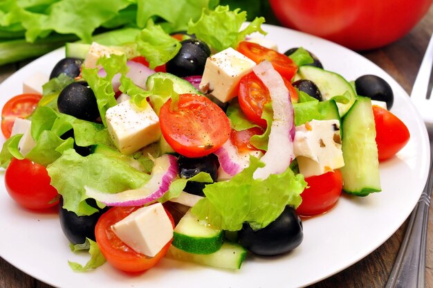 A plate of salad with a red bag behind it