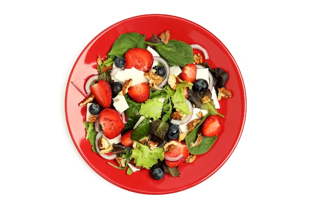 Plate of salad with strawberry isolated on white background