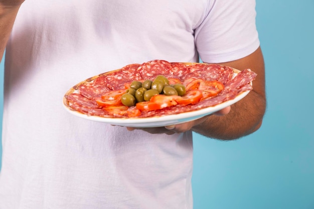 Plate of salami with tomatoes and olives