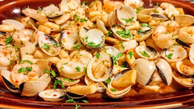 A plate of seafood with a fork and a spoon