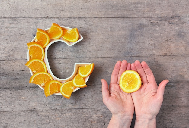 Photo plate in shape of letter c with orange slices