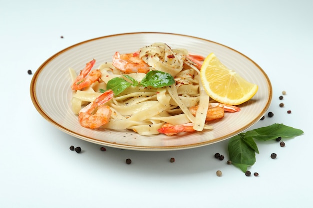 Plate of shrimp pasta on white