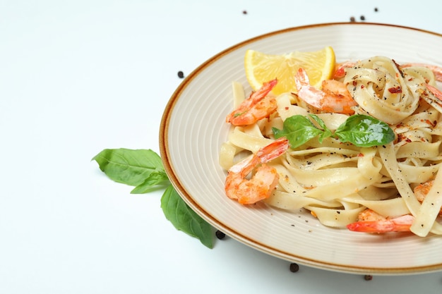 Plate of shrimp pasta on white