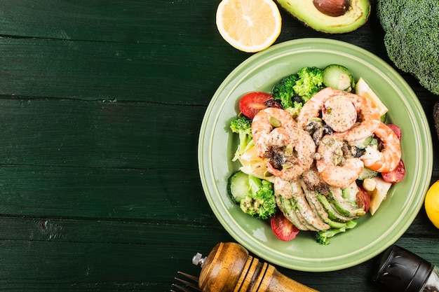 A plate of shrimp salad with vegetables