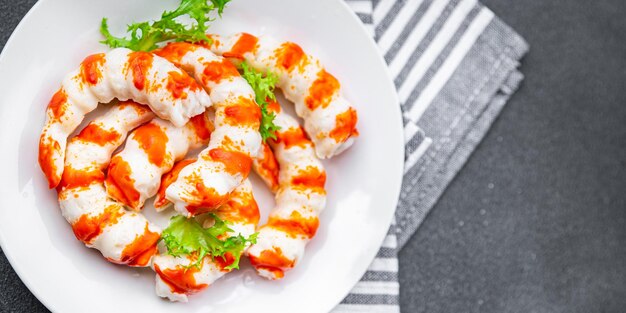 A plate of shrimps with parsley on top