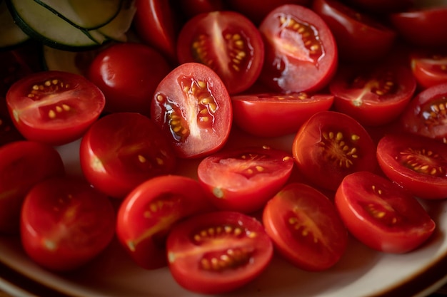 A plate of sliced tomatoes with the seeds of the tomato.