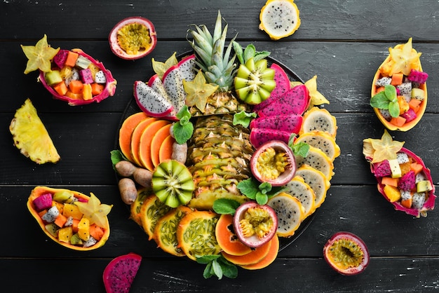 A plate of sliced tropical fruit Top view Free space for text