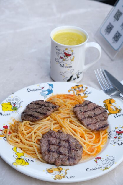 Photo a plate of spaghetti and meats with a cup of coffee