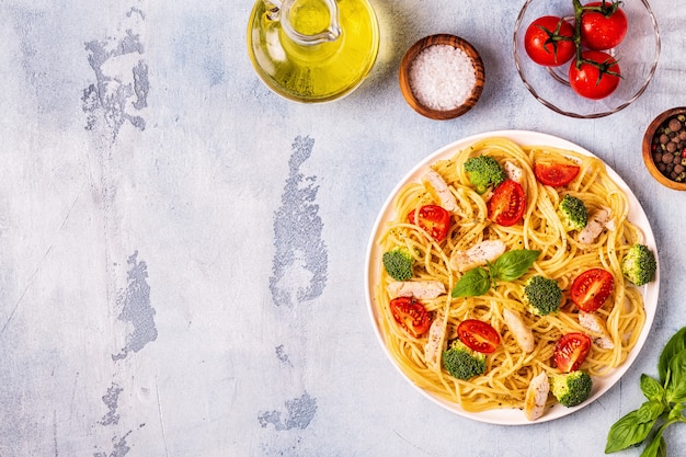 Plate of spaghetti tomato broccoli chicken