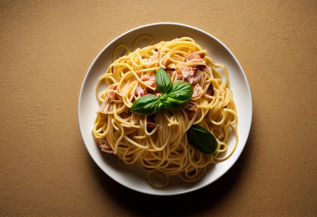 A plate of spaghetti with bacon and basil on top.