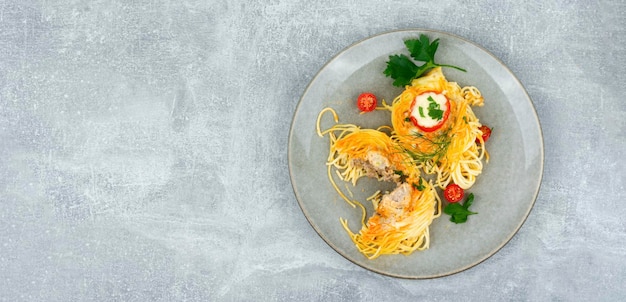 A plate of spaghetti with a tomato sauce and a bowl of sauce.