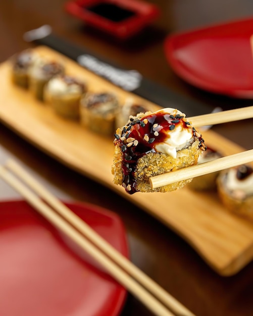 A plate of sushi with a stick of sesame seeds on it