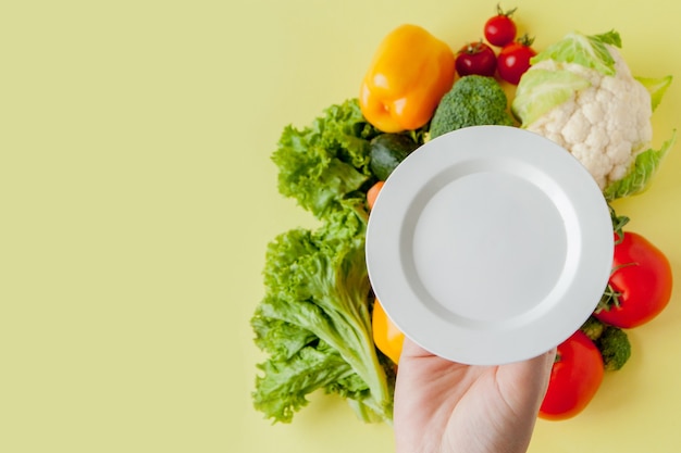 背景においしい食事のためのプレート新鮮な野菜。上面図。料理の背景。