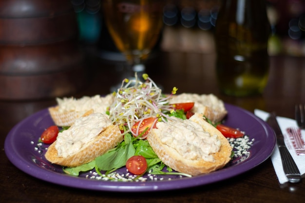 A plate of tuna salad with a salad on it