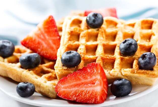 Plate of waffles with strawberry and blueberry