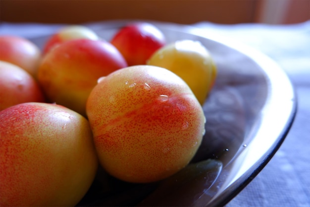 Plate with apricots on the dining table