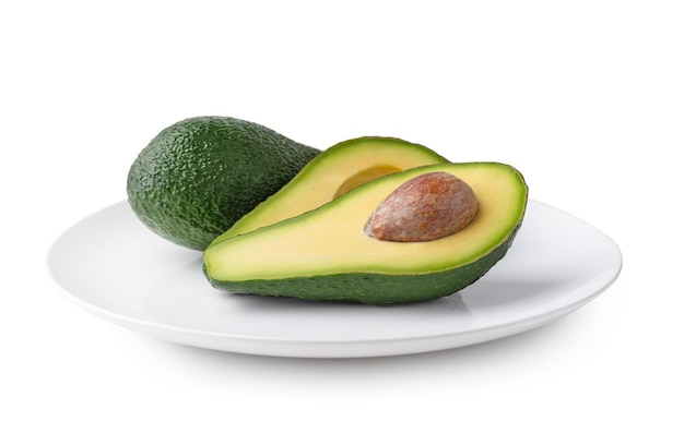 plate with avocado on white isolated background