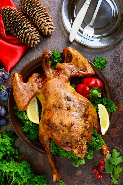 plate with baked chicken with greens top view