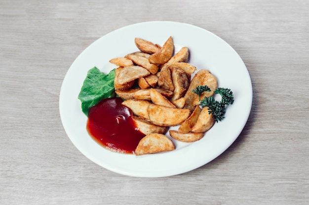 Photo plate with baked potato wedges and sauce