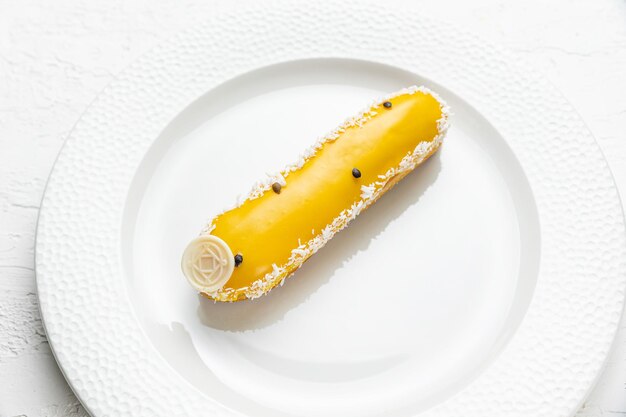 A plate with a banana on it and a white plate with a flower on it.