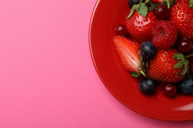 Plate with berry mix on pink