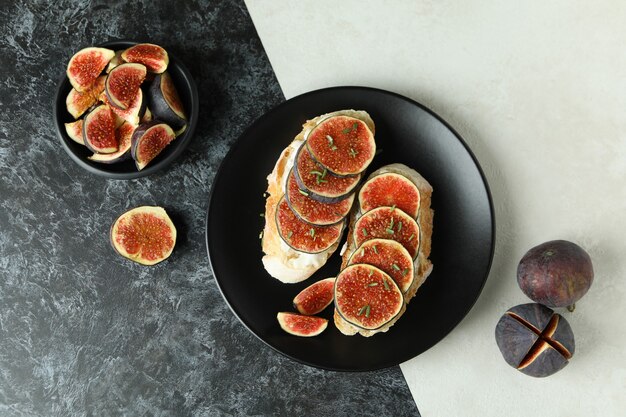 Plate with bruschetta with fig on two tone background