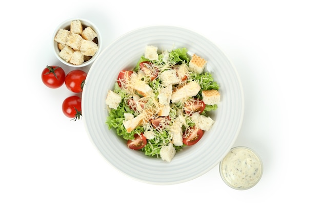 Plate with Caesar salad isolated on white