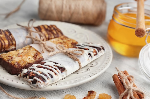 Plate with cereal energy bars on table