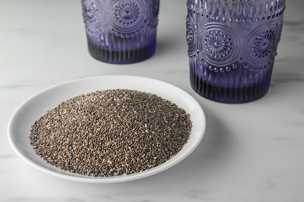 Plate with chia seeds on table