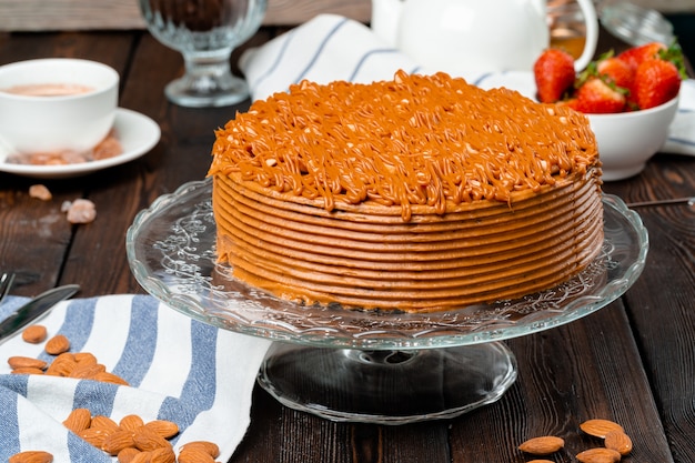 Plate with delicious caramel cake close up