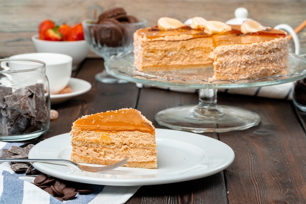 Plate with delicious caramel cake close up