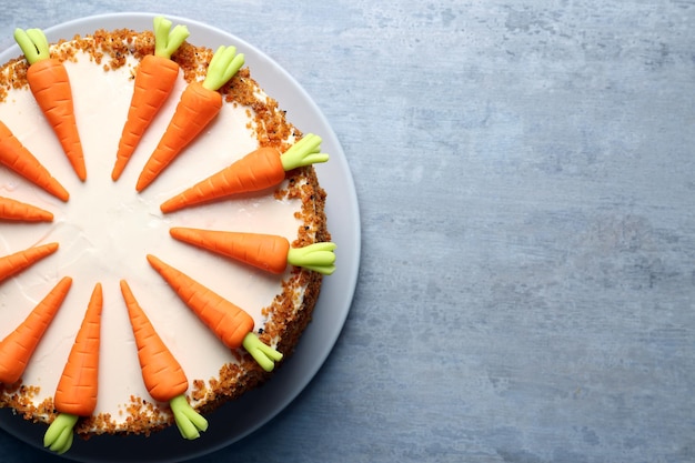 Photo plate with delicious carrot cake on grey table