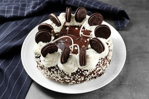 Photo plate with delicious chocolate cake on dark table