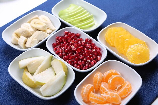 Plate with delicious mixed fruits and sliced fruits