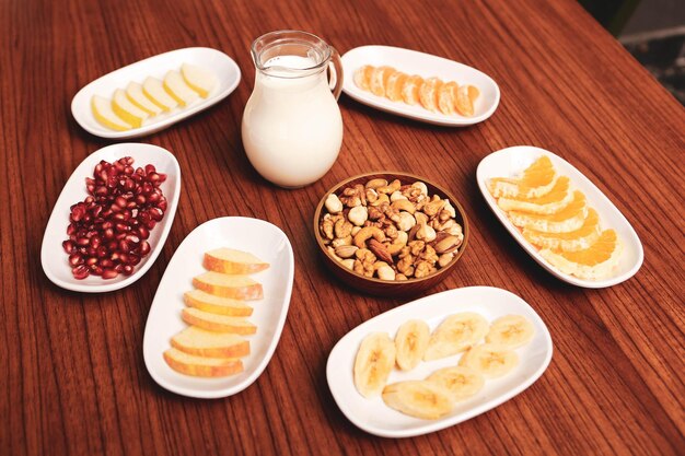 Plate with delicious mixed fruits and sliced fruits