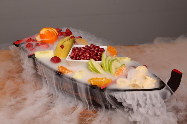 Plate with delicious mixed fruits and sliced fruits